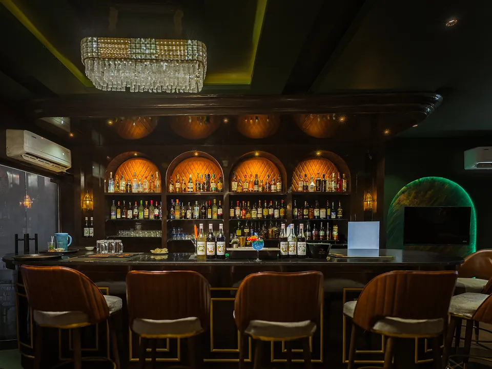 Well-stocked bar counter with crystal chandelier