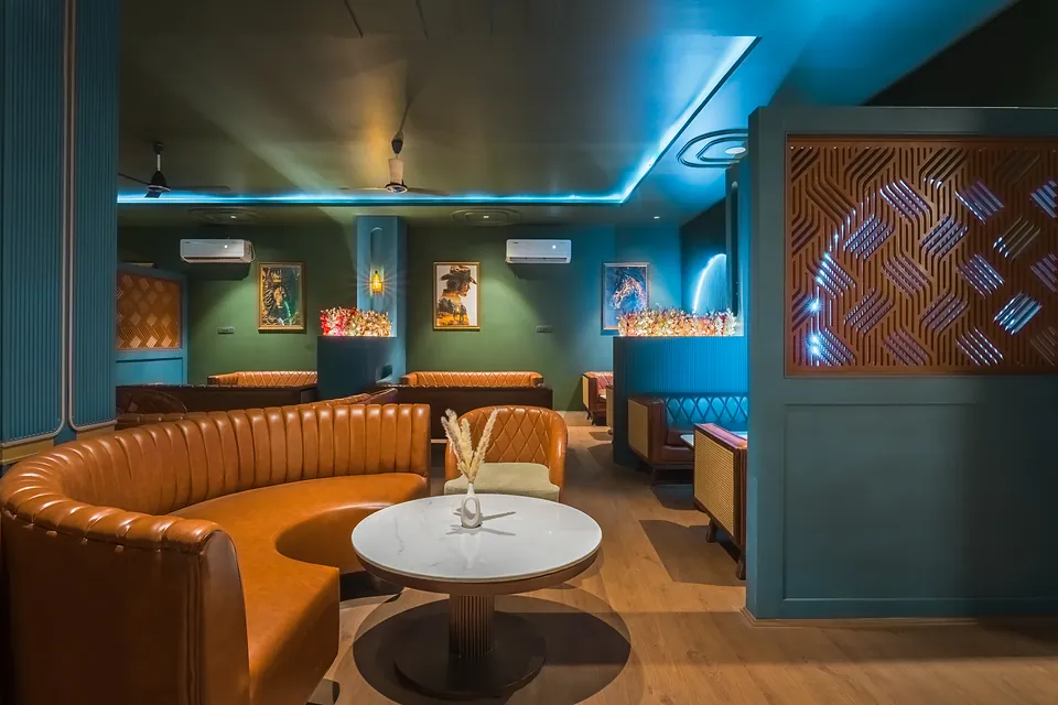 Curved leather booth and teal walls in the Jigyasa Palace bar