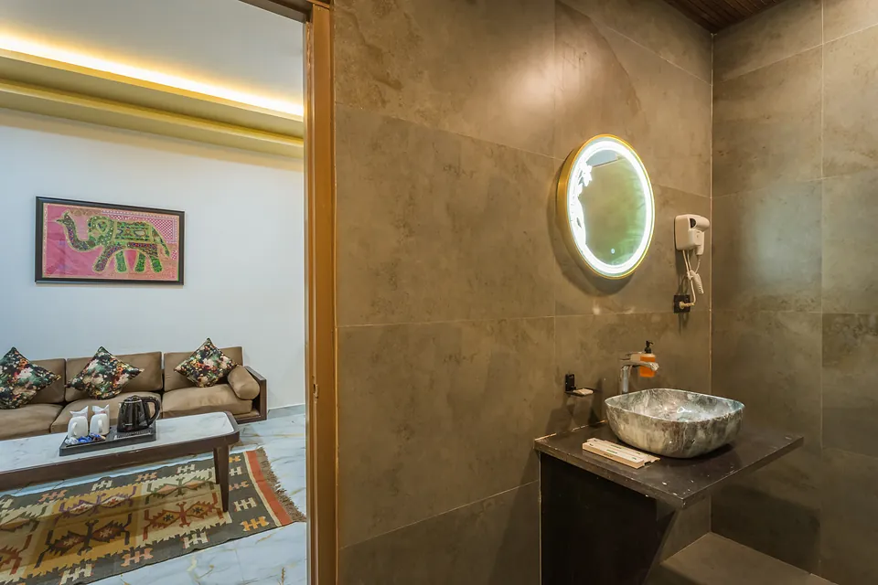 King Suite bathroom with stone vessel basin and LED mirror