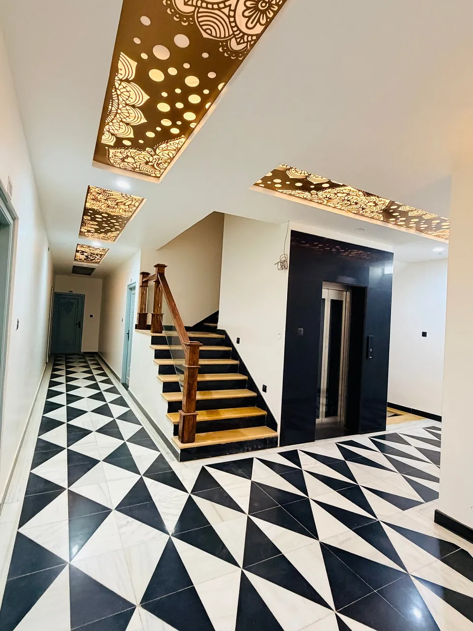 Checkered marble staircase with carved jaali ceiling