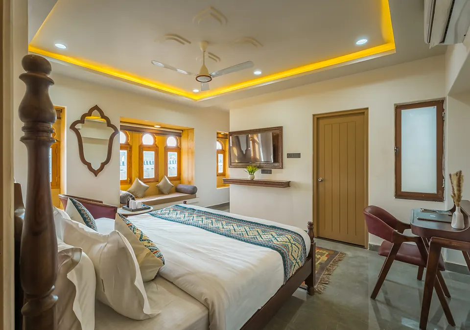 Premier Room bed with Rajasthani runner and carved mirror