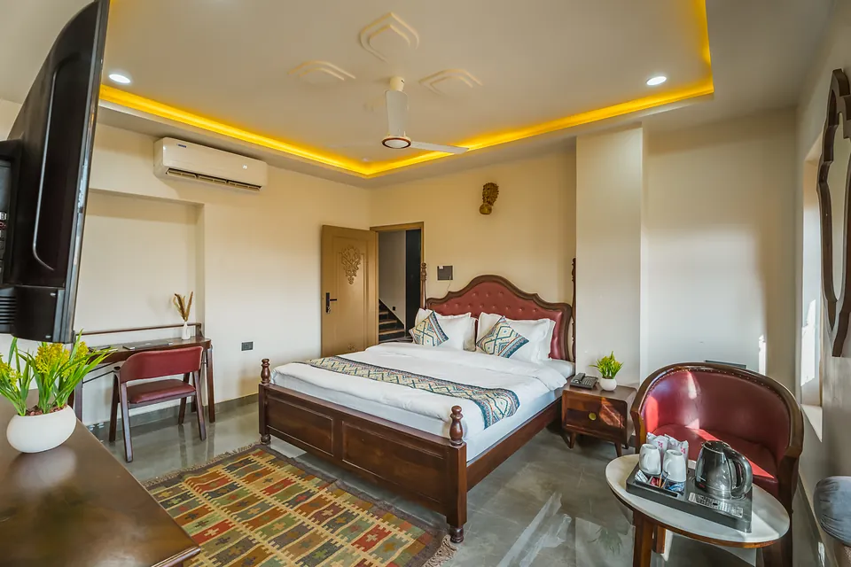 Premier Room with tufted headboard and armchair